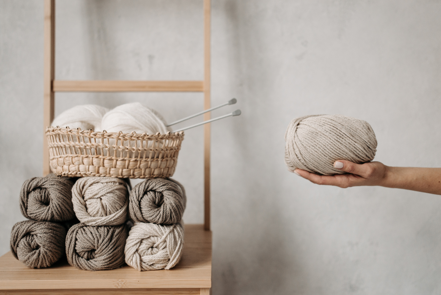 A Roll of Yarn on a Person's Hand