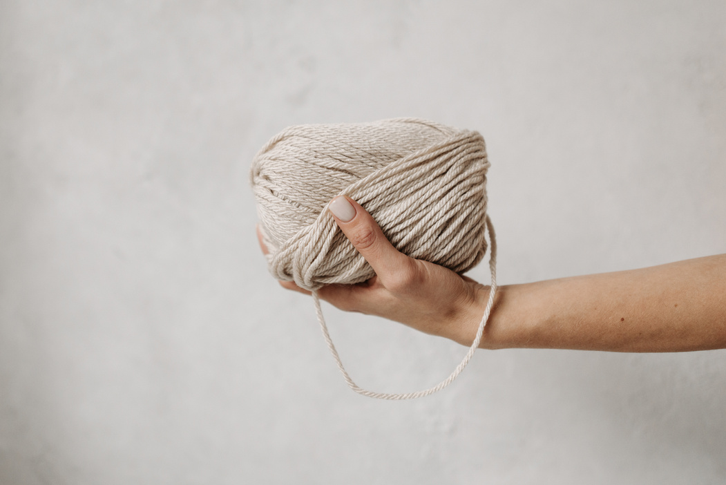 Person Holding Brown Yarn Roll